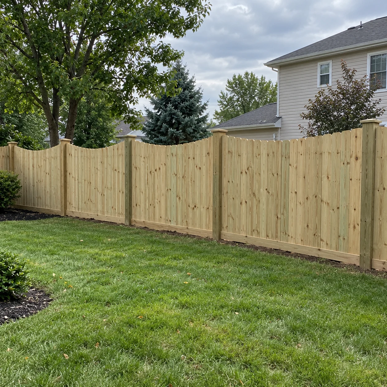 Six-foot scalloped treated wood privacy fence