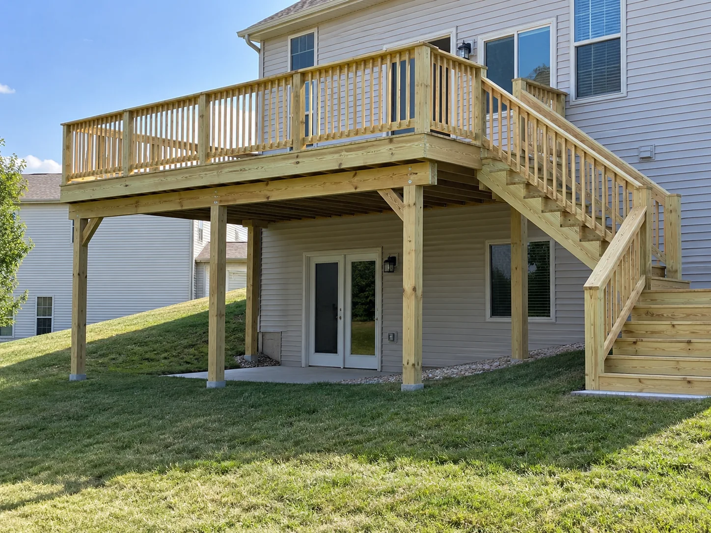 Second-story wood deck with walkout basement and wood spindles