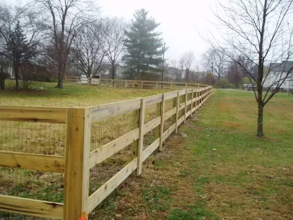 Three-rail fence beside a drive
