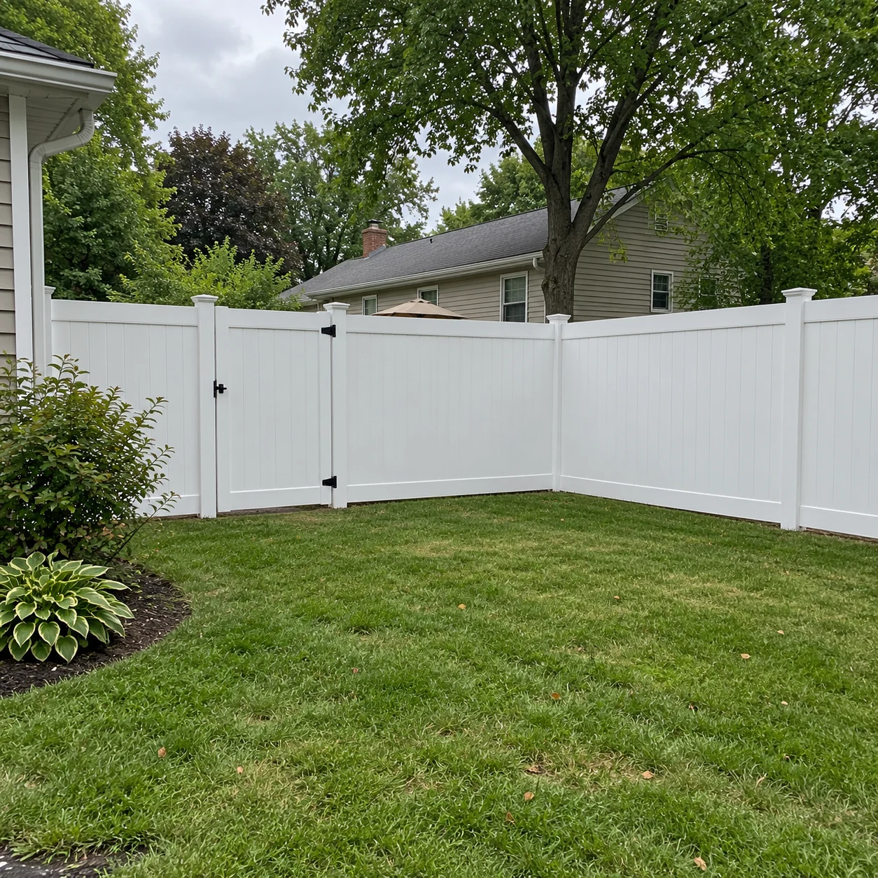 White vinyl privacy fence around a backyard